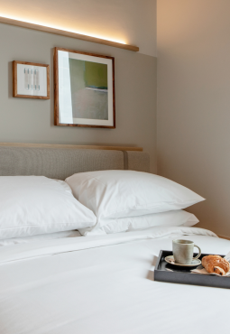 Modern hotel room at Wren Urban Nest with neatly made bed and br
