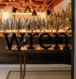 Wren Hotel entrance with modern signage and warm interior lighti